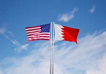 flags of  bahrain and United States of America over blue sky background.