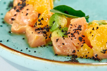 A Vibrant Dish Showcasing Fresh Salmon, Citrus Fruits, and Green Garnishes on a Beautifully Designed Plate for Culinary Appreciation
