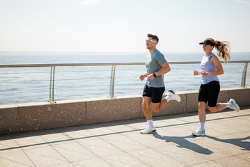 Jogging along the waterfront promenade during a sunny morning