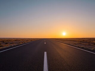 Empty highway stretches into a sunrise
