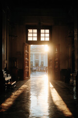 Fototapeta premium open church door reveals warm inviting light spilling into entrance creating stunning atmosphere