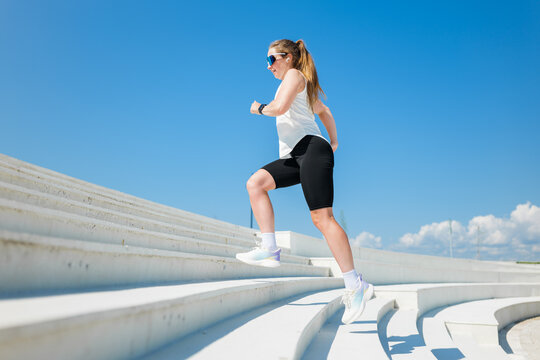 Runner training on the steps of a modern outdoor structure