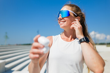 Joyful runner enjoying music under clear blue sky