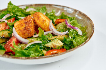 A Colorful and Nutritious Salad Featuring Leafy Greens, Crisp Vegetables, and Golden-Crusted Cheese Bites for a Balanced Meal Experience