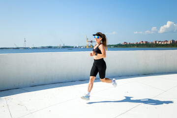 Dynamic runner enjoying a scenic waterfront jog with determination
