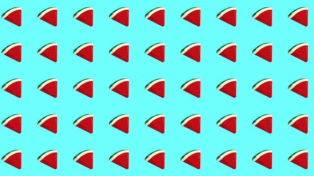 Repeated watermelon slices pattern rotating animation on sky blue background