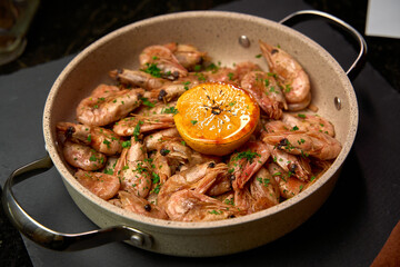 Deliciously Cooked Shrimp with Citrus, Garnished with Fresh Herbs in a Stylish Pan for a Flavorful Seafood Dish