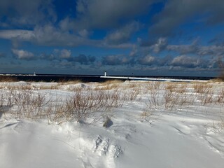 winter landscape with snow covered bridge on the lake