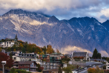 Queenstown in autumn with sunset light casting warm hues on the mountains