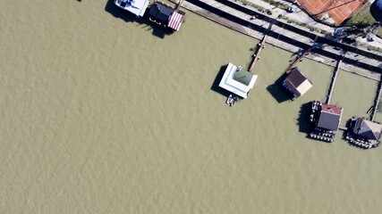 Aerial view of sports complex with tennis courts, pools, and urban riverbank area in Belgrade. C. - Powered by Adobe