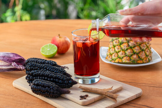Serving a delicious and refreshing chicha morada in a glass.