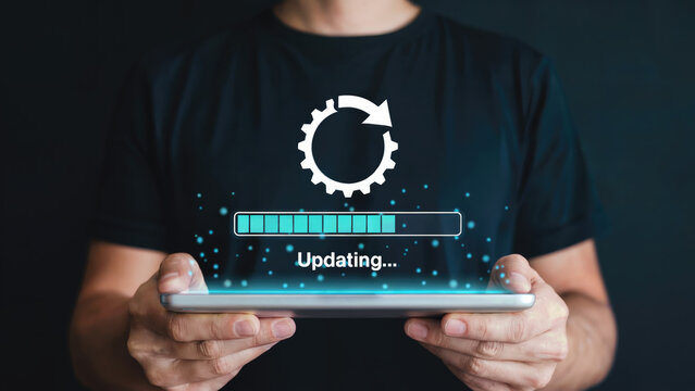 Man updating his tablet software for enhanced performance and modern technology experience today - Powered by Adobe