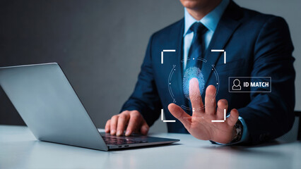 Businessman uses fingerprint scan for secure access and identity verification on laptop, technology security
