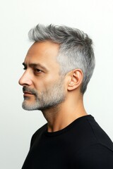 Obraz premium Conceptual art of style for aging men. A peaceful man enjoying a relaxed studio shoot. Trendy men's side part haircut - midlife middle eastern man with short hair. Pure white solid background.