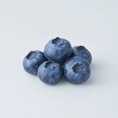 Obraz premium Fresh Blueberries Piled Together on a Light Background for Design