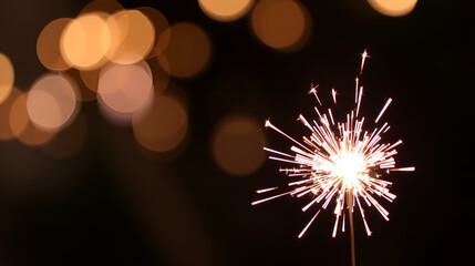 burning sparkler on bokeh background from lights of garland