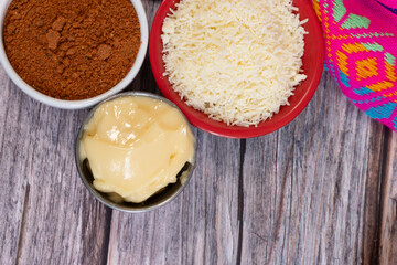 Top view of ingredients for preparing corn on the cob in Mexico, mayonnaise, grated cheese, and spicy chili powder, Mexican food