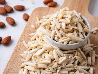 Almond and White Almond Stick set on wooden board and white background.