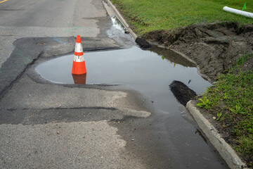Sinkhole on a road with Traffic Cone