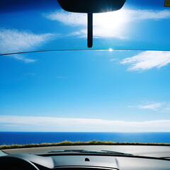 View to the blue sea __and sky through the windshield of a car