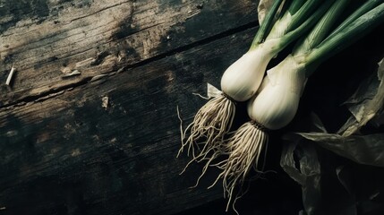 A bunch of fresh garlic bulbs on a rustic table.