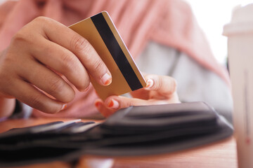 Paying at a cafe with a credit card in hand