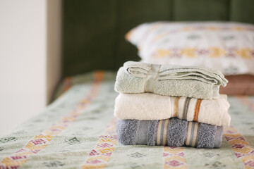 Towels neatly arranged on a bed in a cozy bedroom