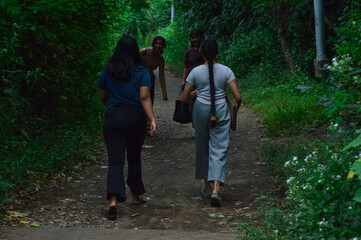 Surrounded by morning mist and thick foliage, the girls stroll slowly through a peaceful natural...