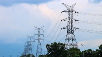 This is tall transmission line tower on clear blue sky background. Electricity high voltage tower.