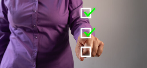 Businesswoman pointing at a check mark inside a square on a to-do list