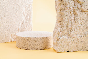 Empty stone podium against a beige wall background, ideal for mockups and showcasing cosmetic...