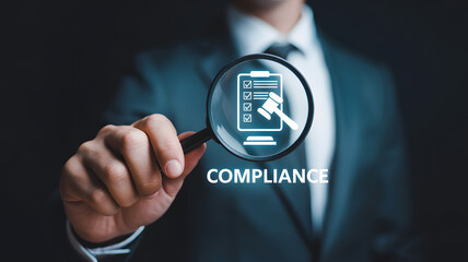 Business professional examining legal compliance with magnifying glass