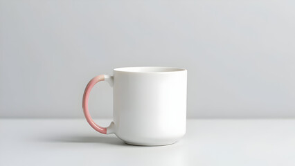 A white mug with a pink handle on a white surface