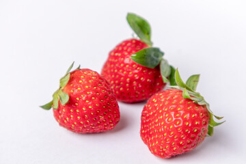 Three strawberries isolated on a white background