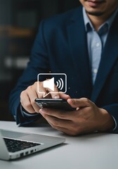 Businessman holding a smartphone with a speaker icon representing sound notification concept