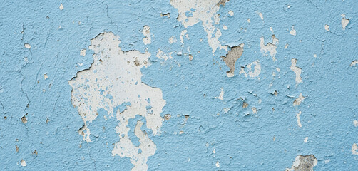 Blue wall with peeling white paint creating a textured and distressed surface, combining aged character and color contrast for a vintage look and raw aesthetic in visual compositions.