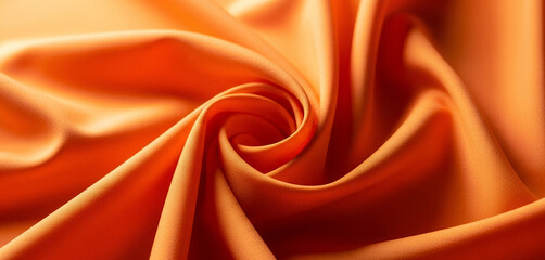 Close-up of an orange fabric with a swirl pattern and soft textures, creating warm visual flow and gentle motion perfect for elegant design accents or textile-inspired compositions.