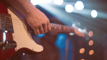 The artist plays the guitar.