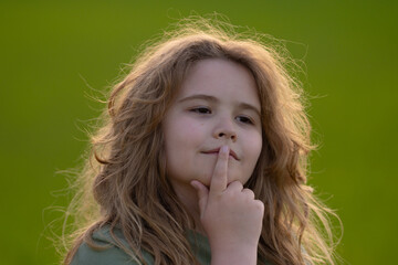 Kid looking away. Child thinking with a doubtful look. Portrait of a child imagining deeply. Dreamy...