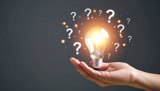 Hand holding glowing bulb surrounded by question marks—symbolizing ideas, inquiry, and innovation