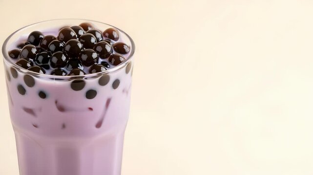 Glass of Refreshing Taro Bubble Tea with Tapioca Pearls on Neutral Background