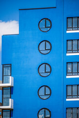 A fragment of the facade of a multi-storey residential building under construction on a summer day