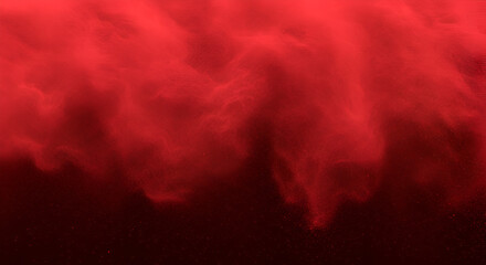 Red abstract cloud-like particles against a dark background