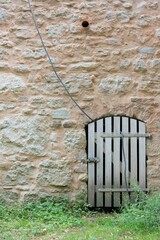Wooden gate in historic city wall, medieval architecture detail