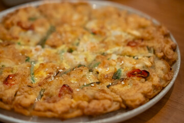 Pajeon, a Korean dish made from a batter of eggs, wheat flour, rice flour, scallions, with other ingredients. Korean Scallion Pancake