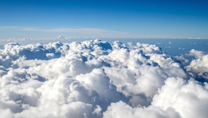 High-altitude view of puffy white clouds against a vibrant blue sky