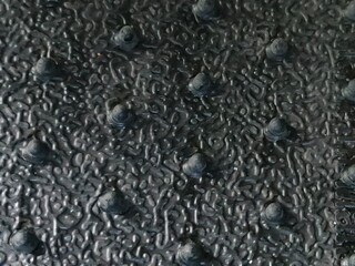 Close-up of textured black rubber surface with round raised anti-slip bumps
