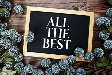 All The Best text with flowers decoration on wooden background