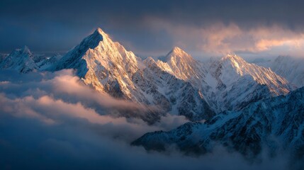 Sunlit snow-capped mountain peaks emerging above low clouds, golden sunrise light