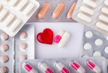Multi-colored tablets and capsules in blister packaging, pharmaceutical industry concept